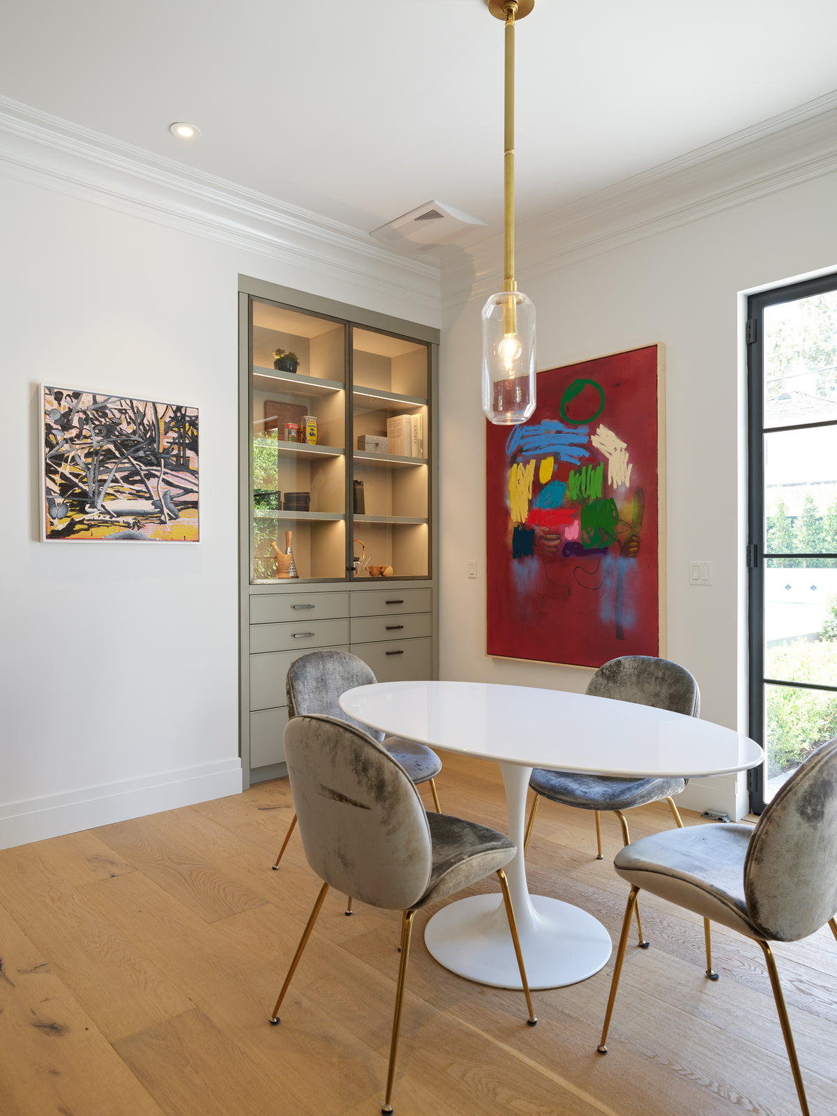 Oval table beside built-in oak cabinetry in the breakfast room, Martin & Brockett Beverly Hills