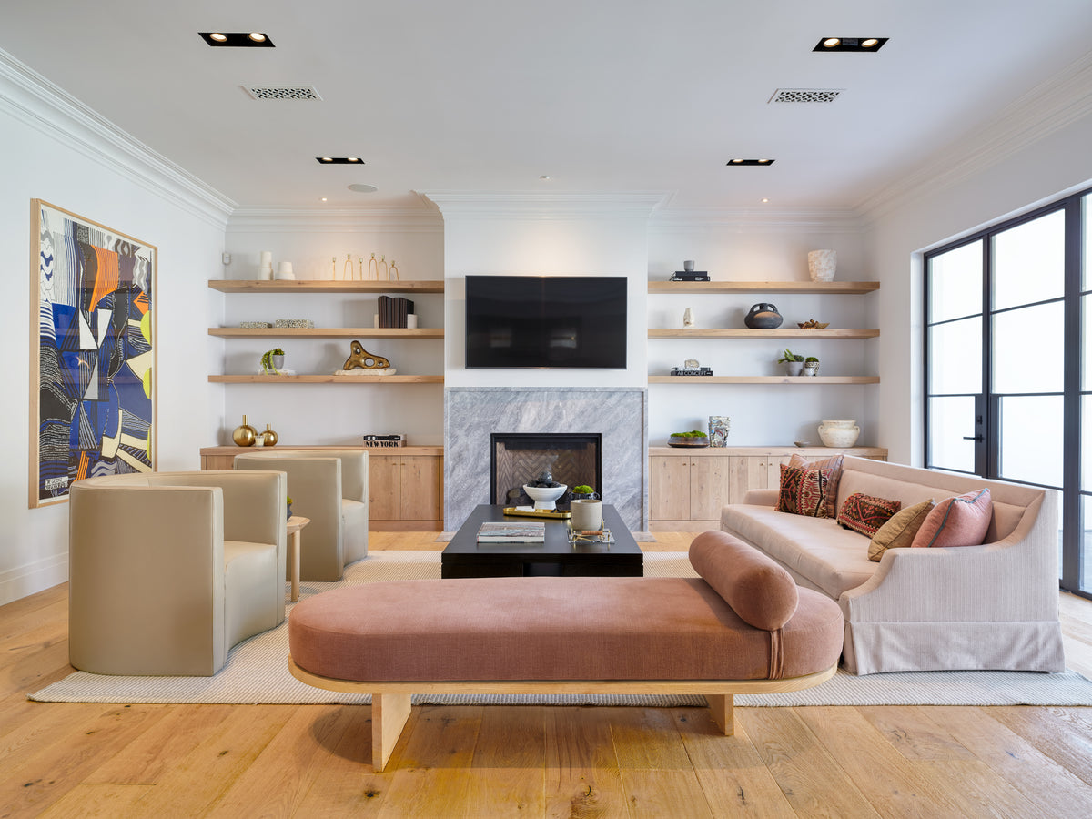 Marble slab fireplace flanked by oak floating shelves in the family room, Martin & Brockett Beverly Hills