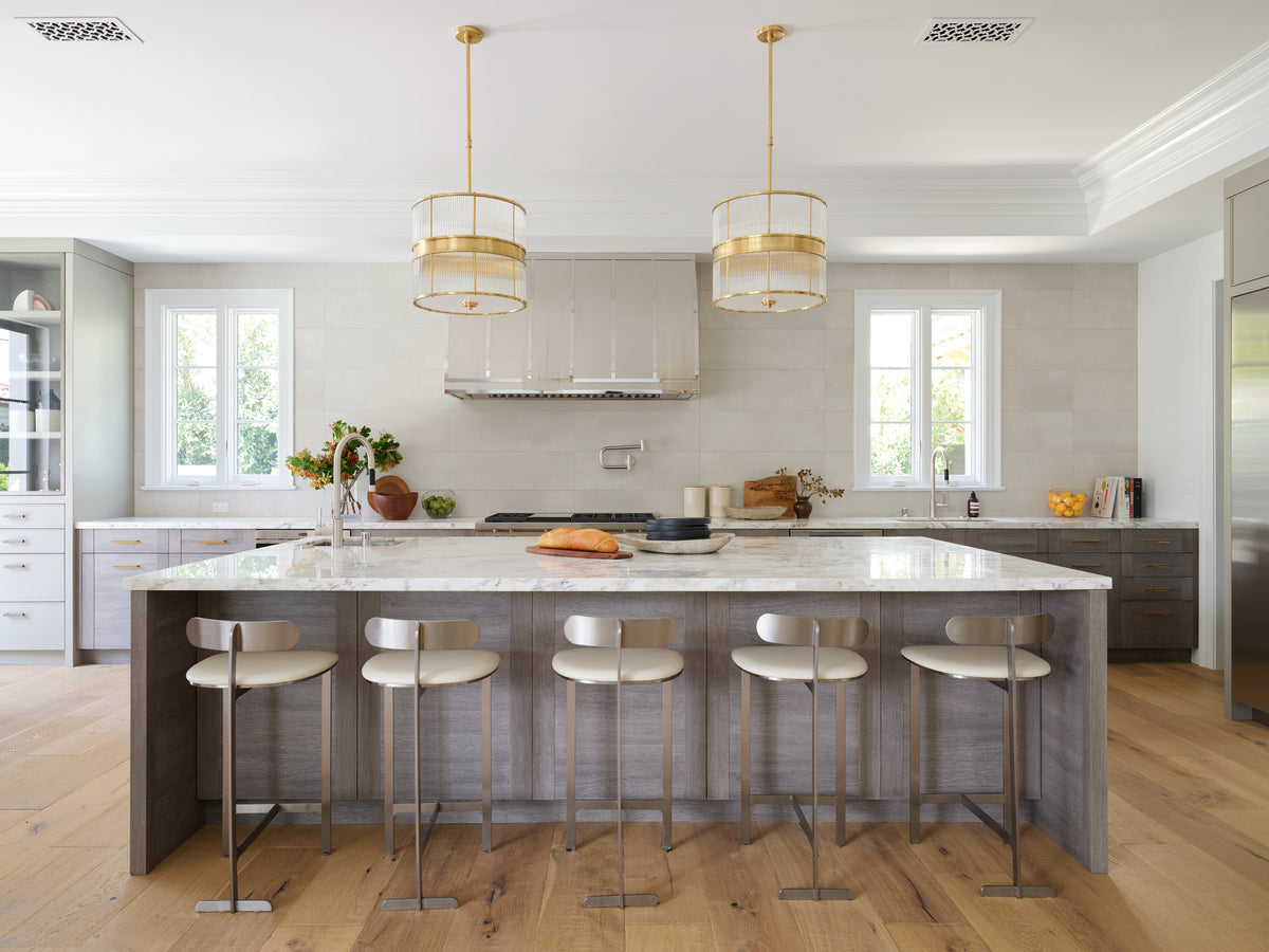Marble island and range hood in the Beverly Hills kitchen by Martin & Brockett