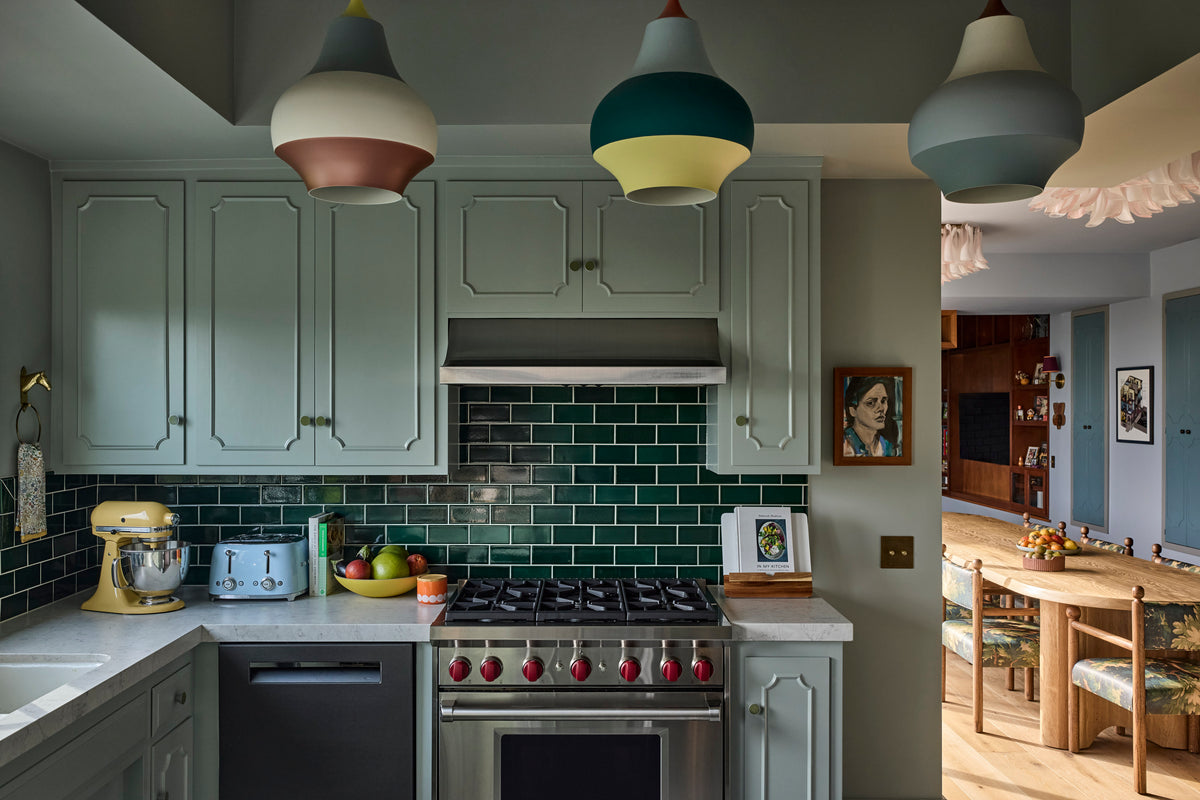 Sage cabinetry and dark green subway tile behind the range, Martin & Brockett Canyon kitchen