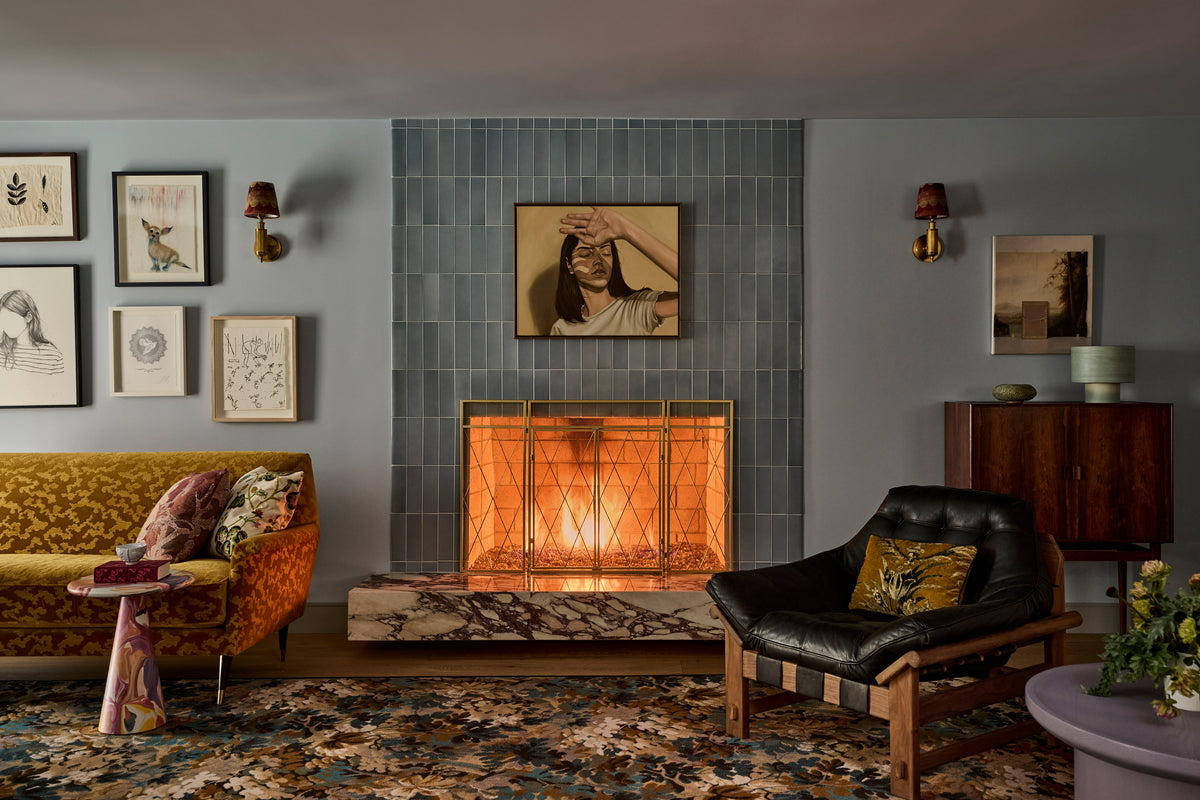 Blue-grey tiled fireplace above a marble hearth, hung with a portrait, Martin & Brockett Canyon