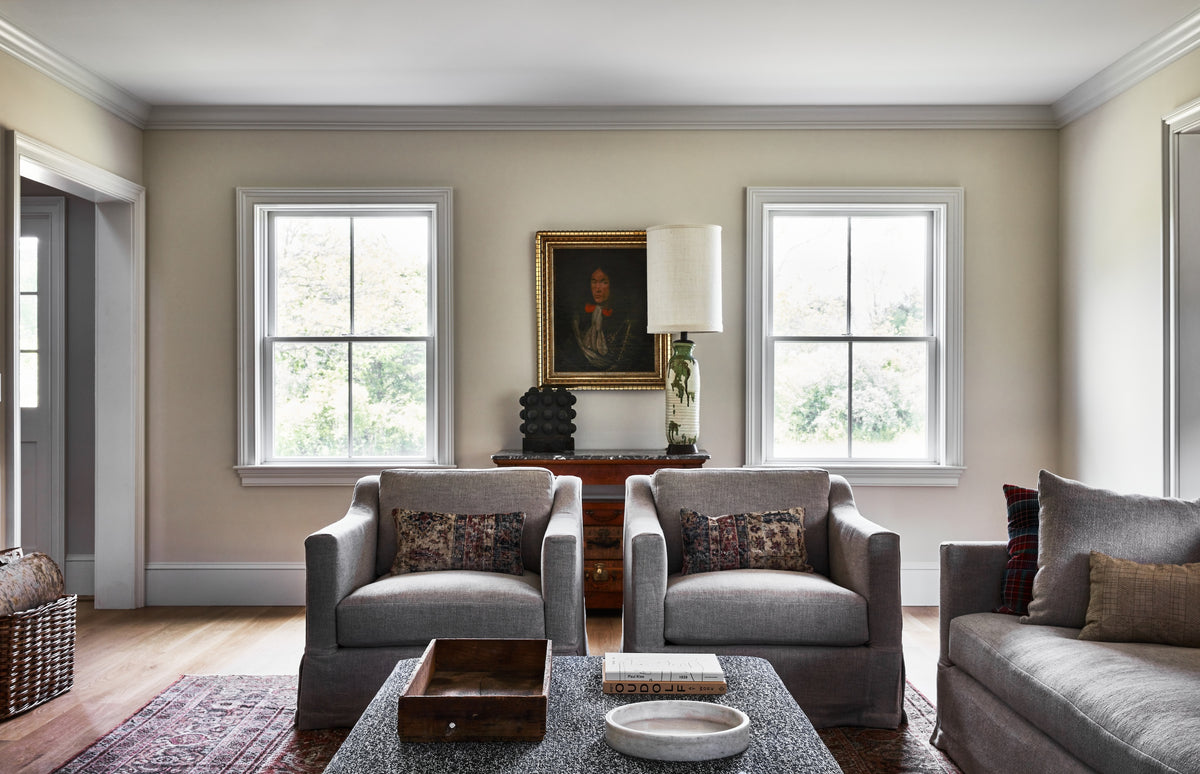 Antique portrait above a chest between paired armchairs, Martin & Brockett Hudson Valley living room