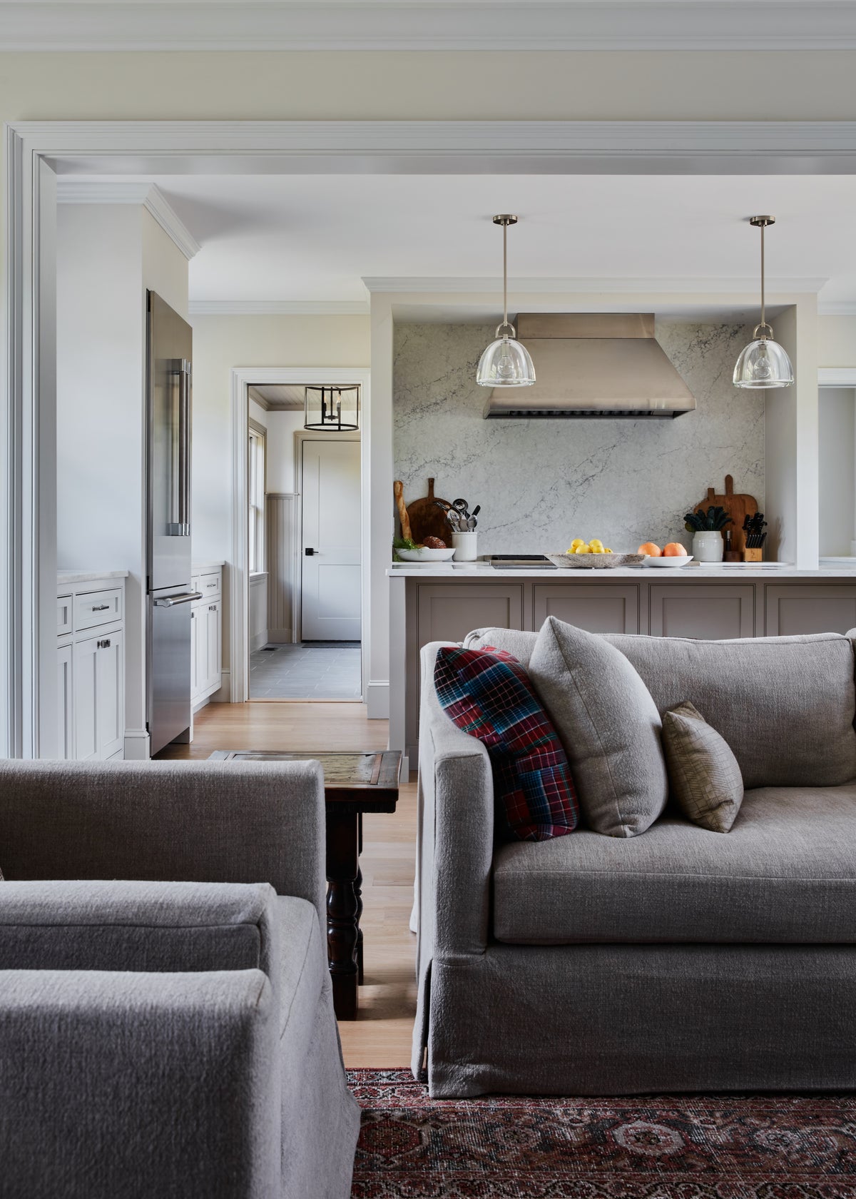 Sectional sofa looking through to the marble kitchen beyond, Martin & Brockett Hudson Valley