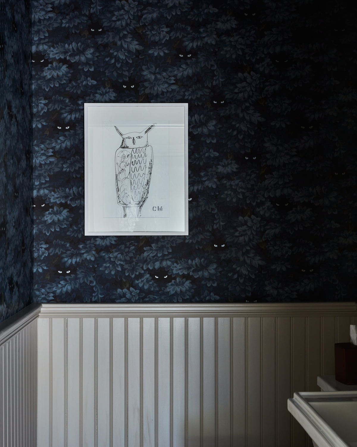 Framed owl print on dark botanical wallpaper above beadboard, Martin & Brockett Hudson Valley powder room