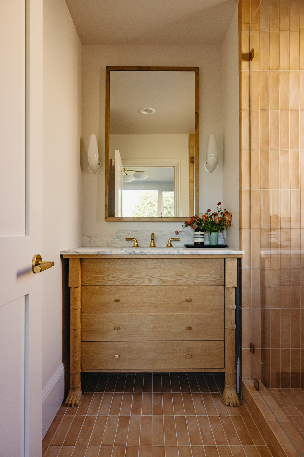 Wood-framed mirror and sconces above the oak vanity, Martin & Brockett Pasadena bathroom