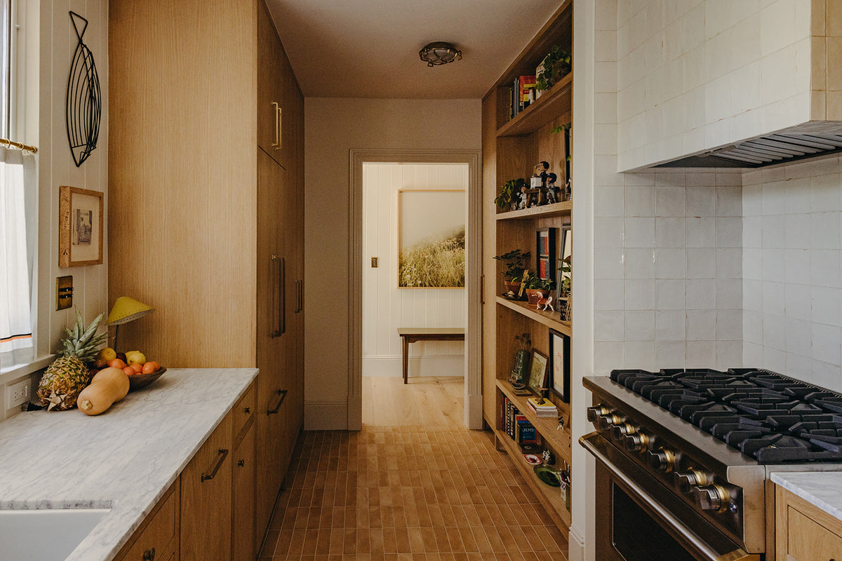 Professional range and open pantry shelving in the Martin & Brockett Pasadena galley kitchen