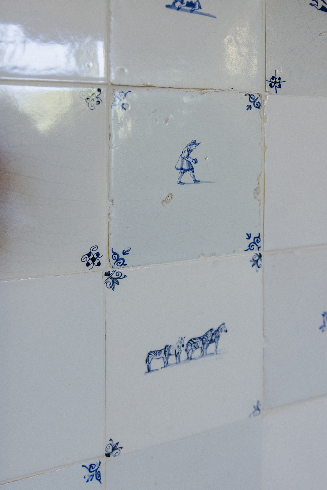 Individual hand-painted Delft tiles photographed close, a detail from Martin & Brockett Pasadena