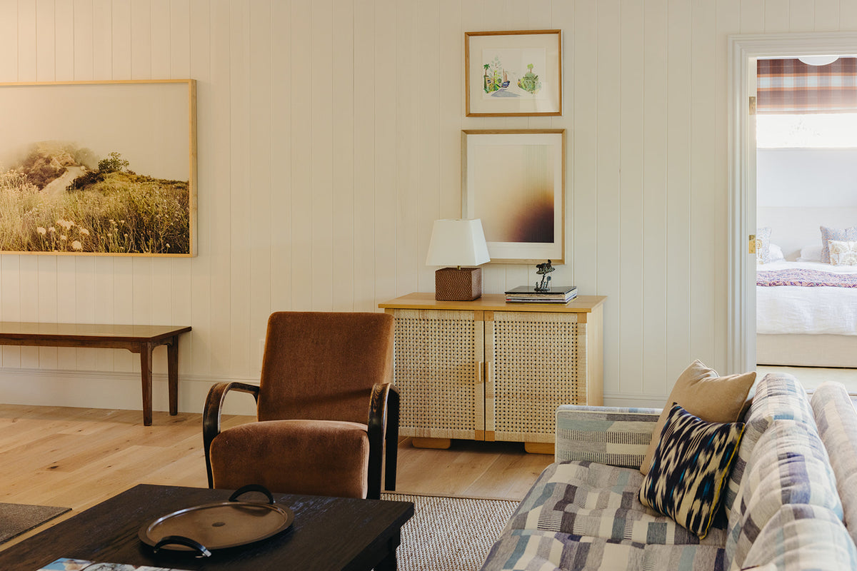 Striped sofa and cane credenza layered in the Martin & Brockett Pasadena living room