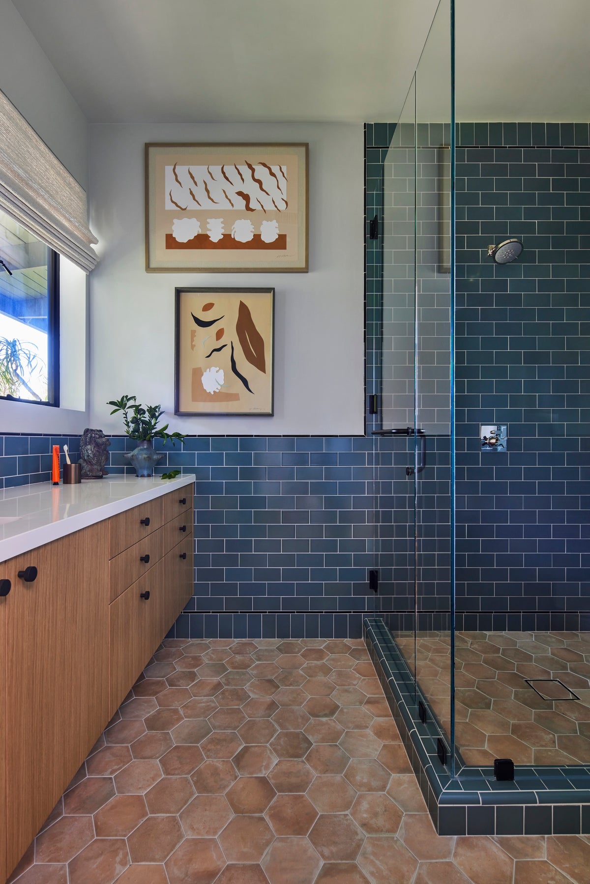 Blue glazed tile shower above a terracotta hex floor, Martin & Brockett San Rafael guest bathroom