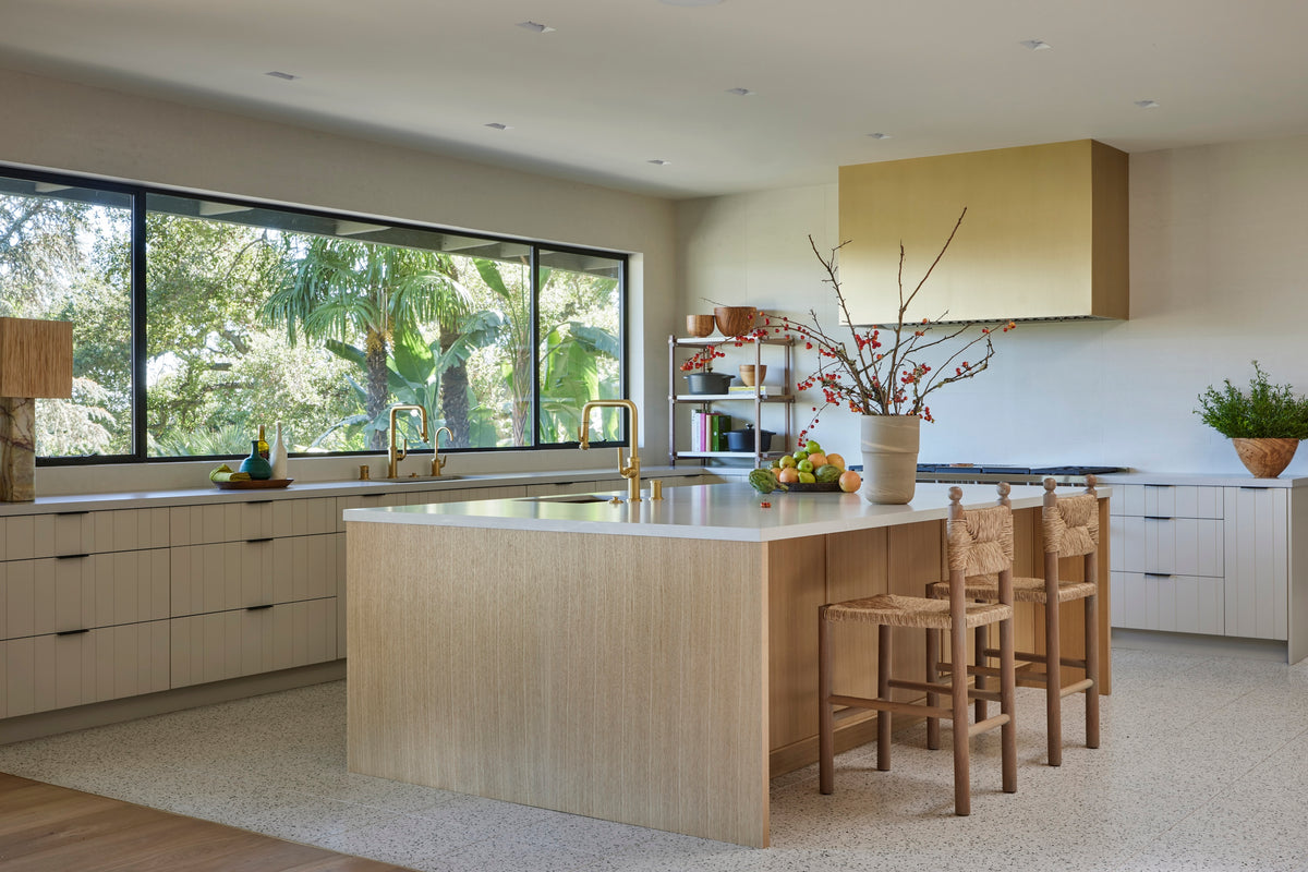 White oak island with woven stools below a picture window to the garden, Martin & Brockett San Rafael kitchen