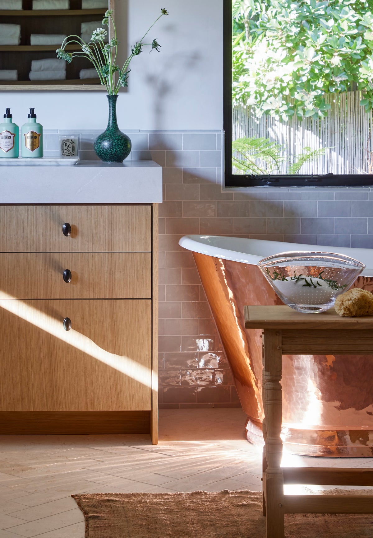 Sunlight across the oak vanity beside the copper tub, Martin & Brockett San Rafael primary bathroom