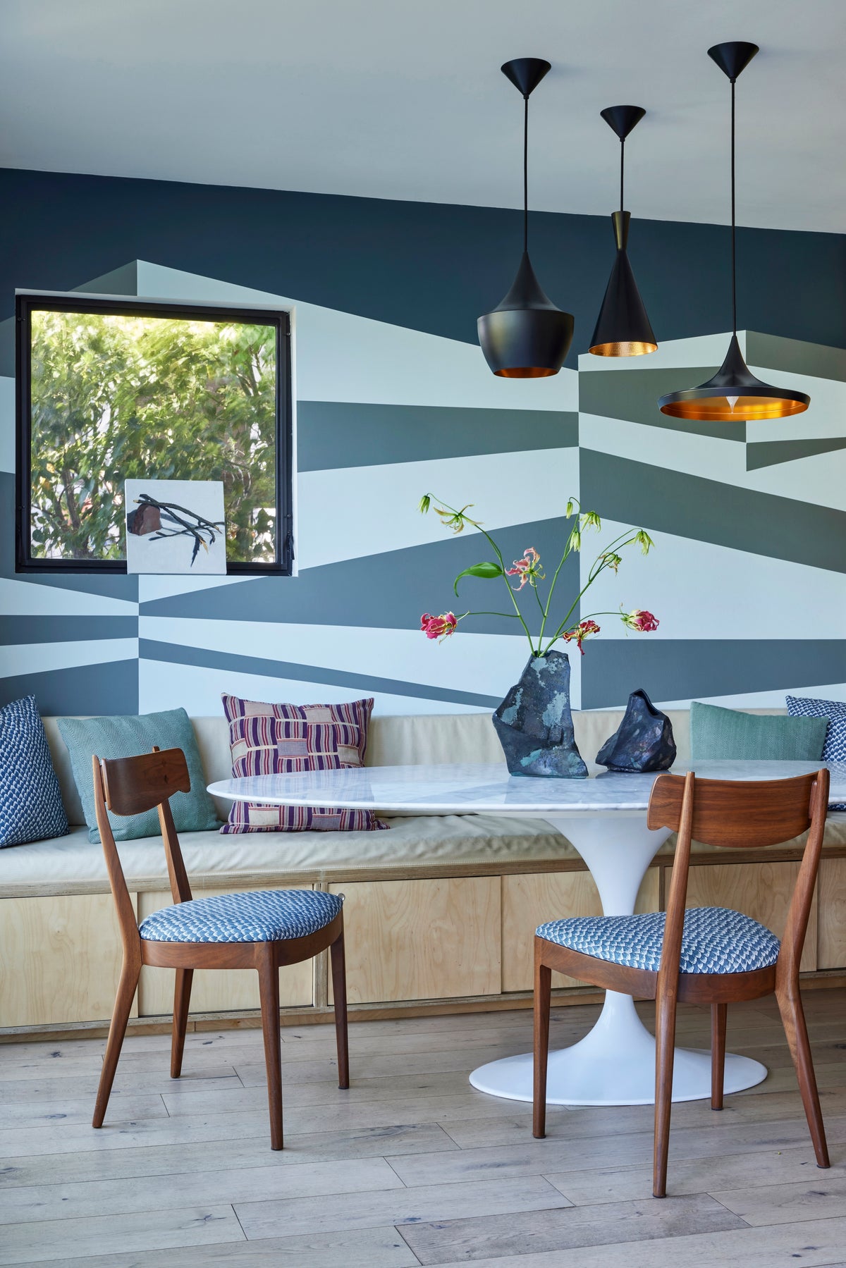 Painted geometric mural behind a tulip table and banquette, Martin & Brockett Silverlake breakfast nook