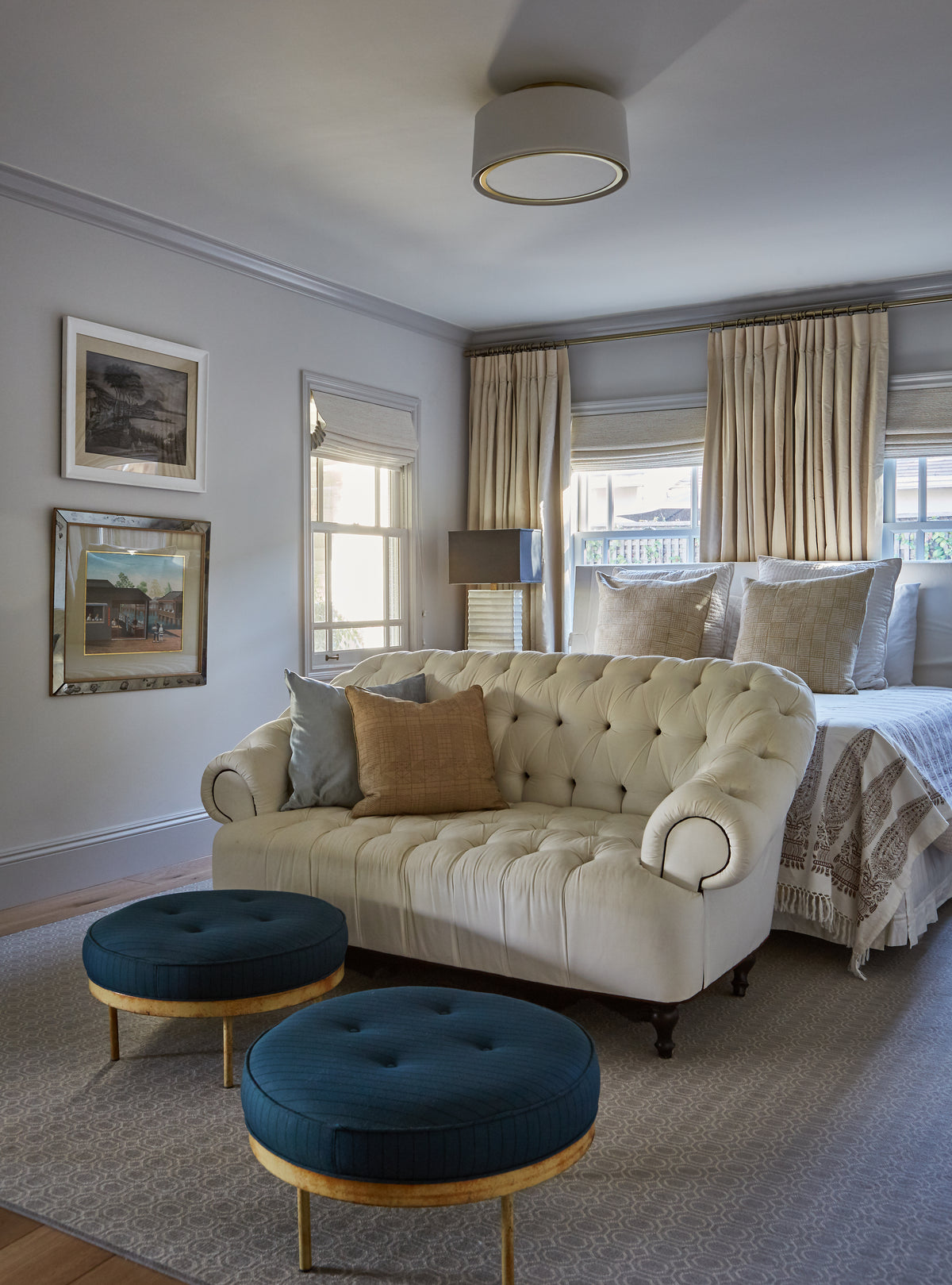 Tufted settee and velvet ottomans at the foot of the bed, Martin & Brockett Studio City
