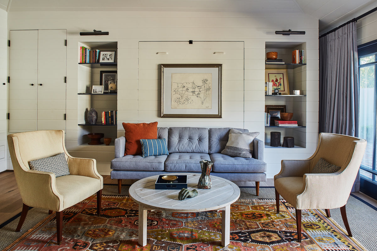Built-in shelving flanking a sofa above a patterned rug, Martin & Brockett Studio City family room