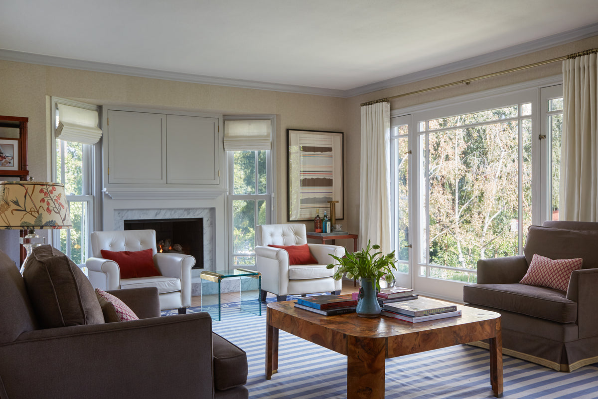 Marble fireplace and burl coffee table anchoring the living room, Martin & Brockett Studio City