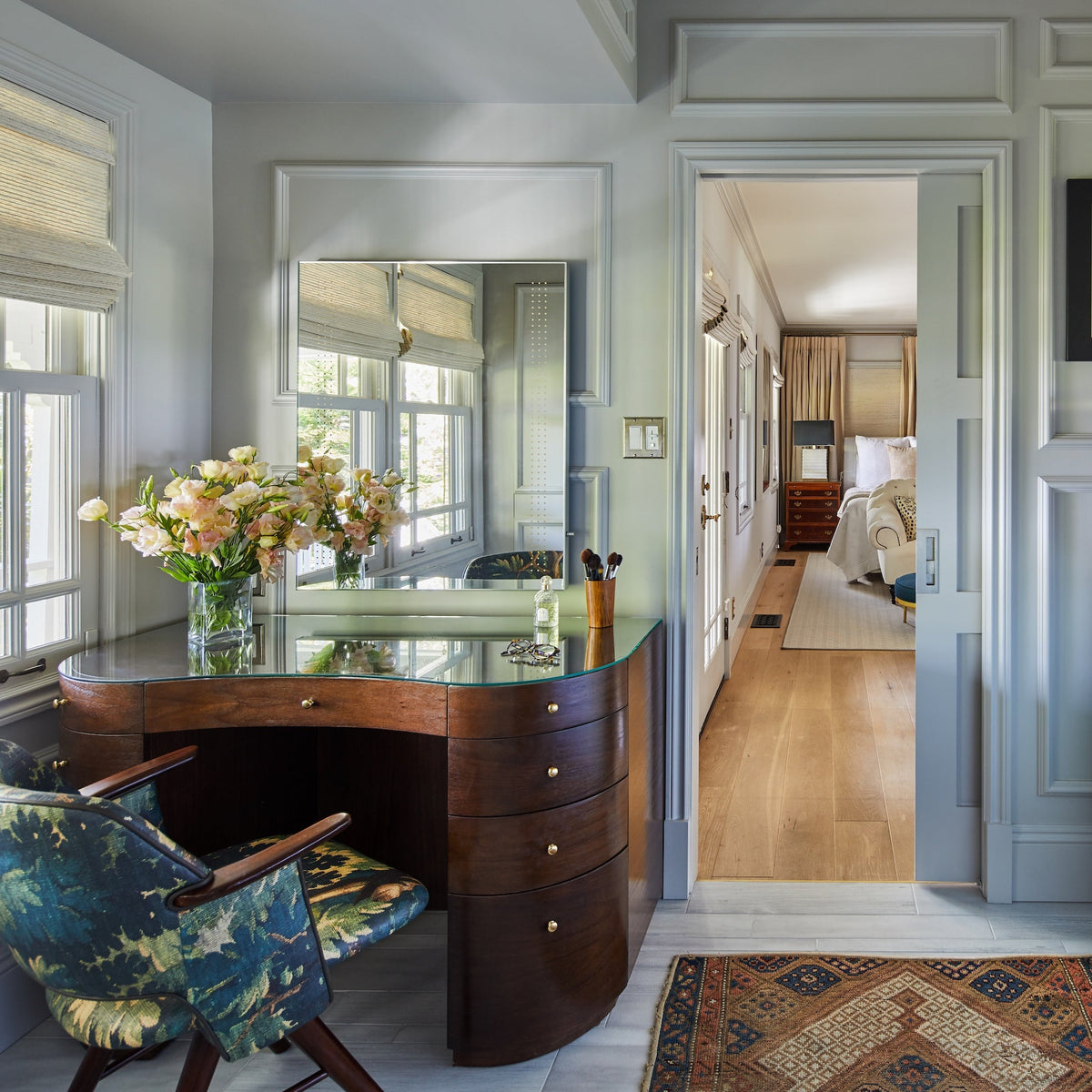 Antique vanity desk beside twin sinks in the primary bathroom, Martin & Brockett Studio City