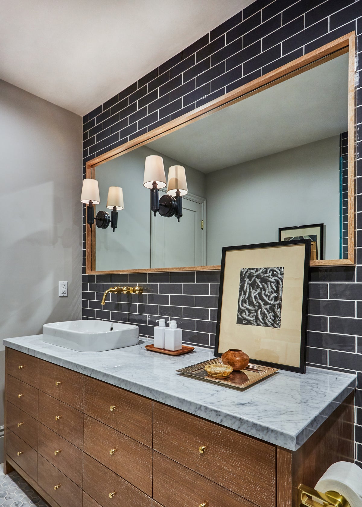Walnut vanity and marble counter below twin sconces, Martin & Brockett Toluca Lake bathroom