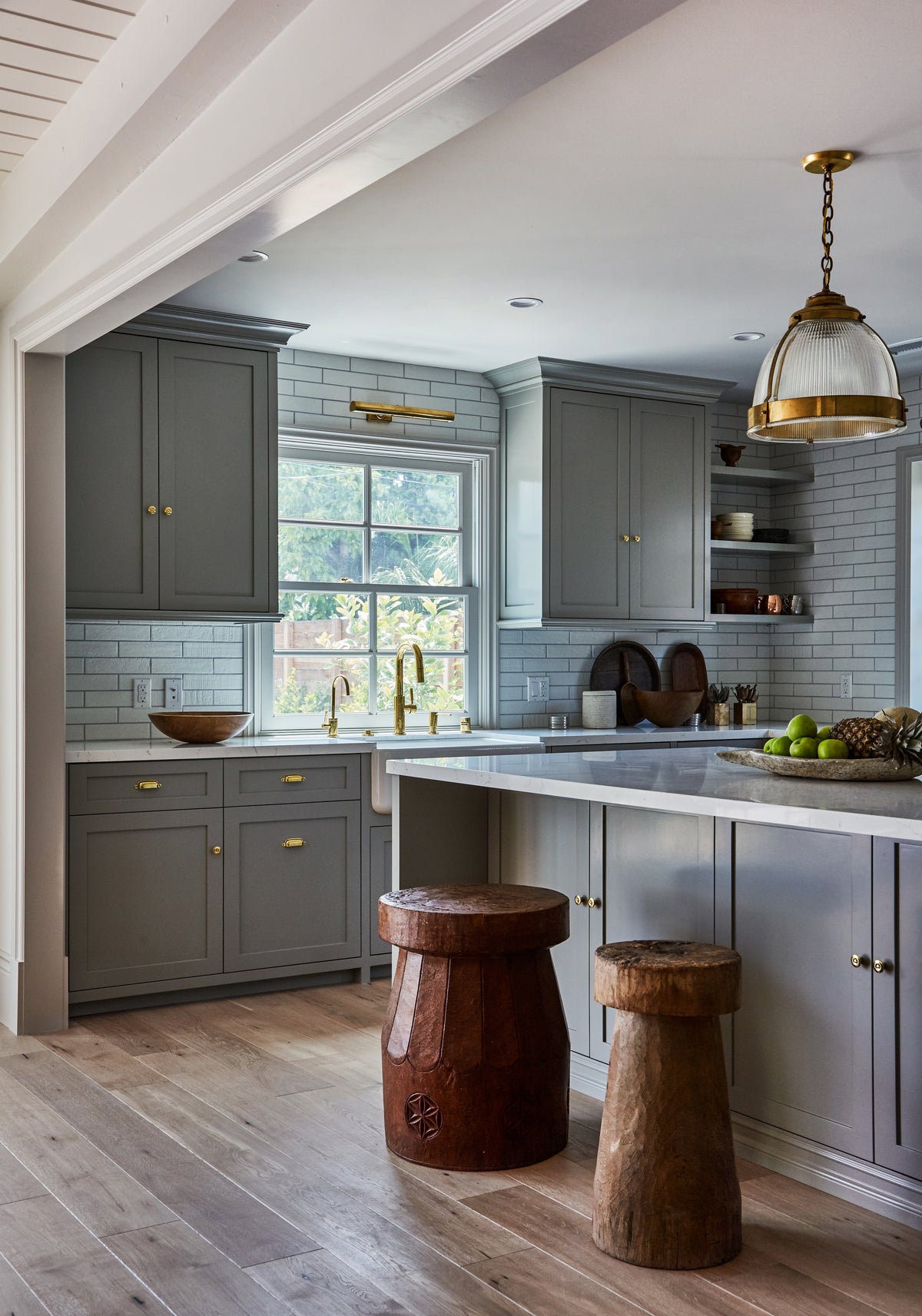 Glass dome pendant below the vaulted beamed ceiling, Martin & Brockett Toluca Lake kitchen