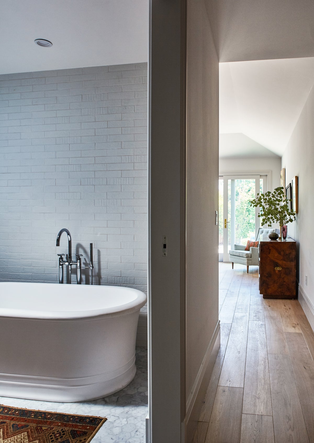 Freestanding tub seen through the doorway to the bedroom, Martin & Brockett Toluca Lake
