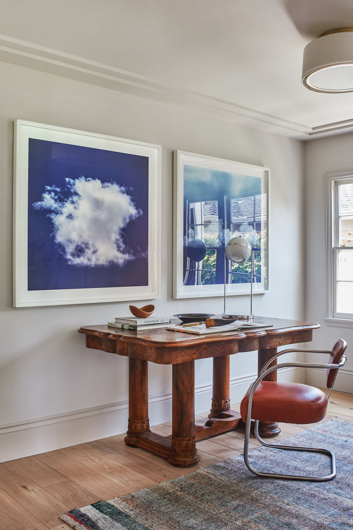 Wood desk and leather chair below paired cloud paintings, Martin & Brockett Toluca Lake study